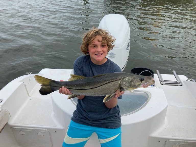 a boy that caught a snook on a seafox boat