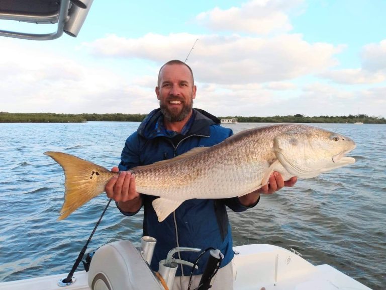 captain eric of drop em down fishing charters with a redfish on a seafox boat